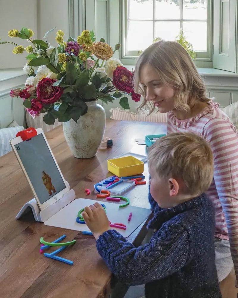 A little one playing with the Little Genius Starter Kit at home
