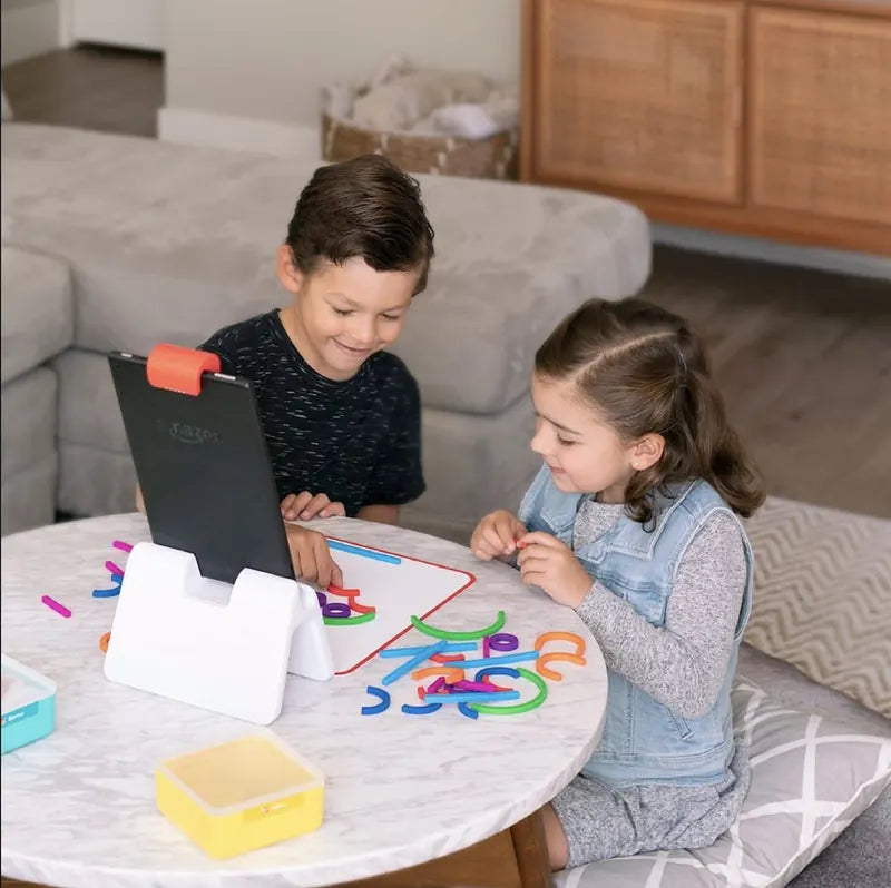A little one playing with the Little Genius Starter Kit at home