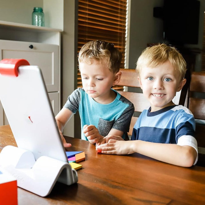 Two brothers playing Osmo Tangram at the dining table