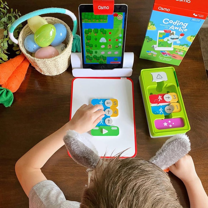 Osmo Coding Awbie game on a tablet with coding blocks on the table