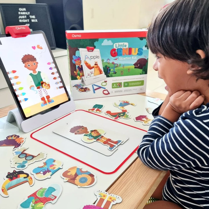 A boy playing Costume Party with the Little Genius Starter Kit