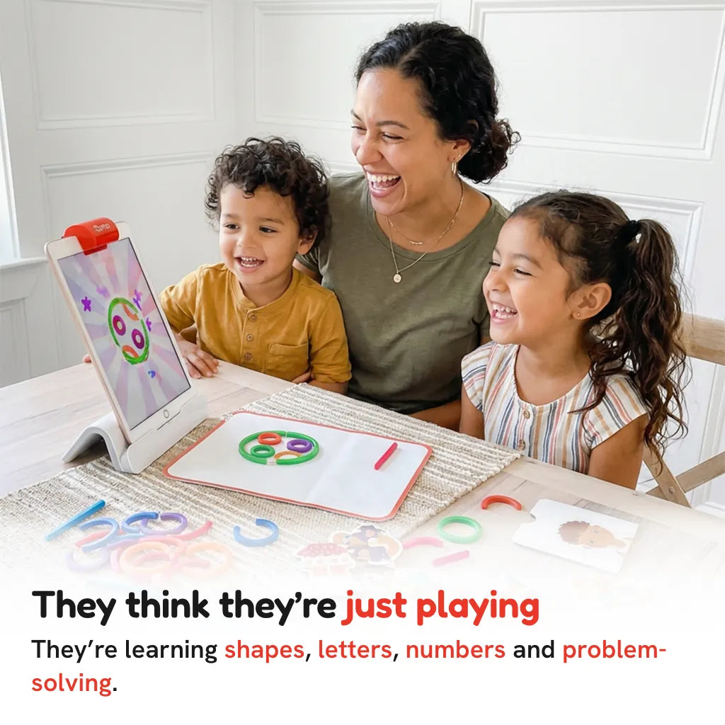A mom and two kids laughing while they play Little Genius at the kitchen table