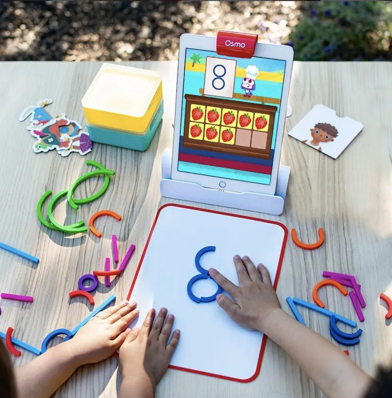A little one playing with the Little Genius Starter Kit at home