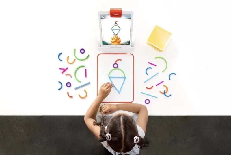 A little one playing with the Little Genius Starter Kit at home