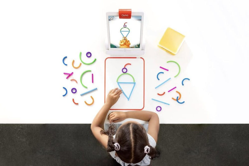 A little one playing with the Little Genius Starter Kit at home
