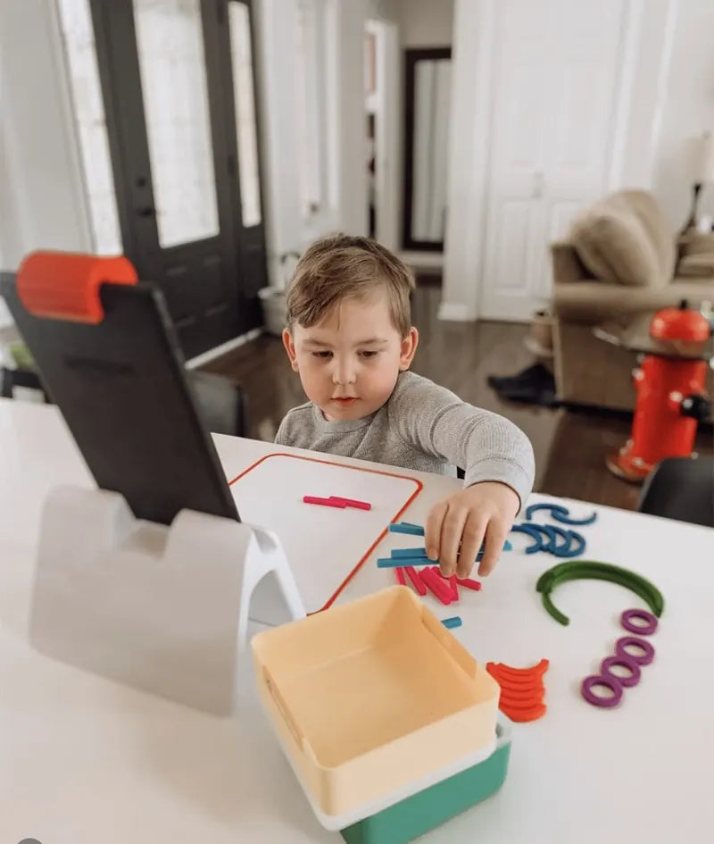 A little one playing with the Little Genius Starter Kit at home