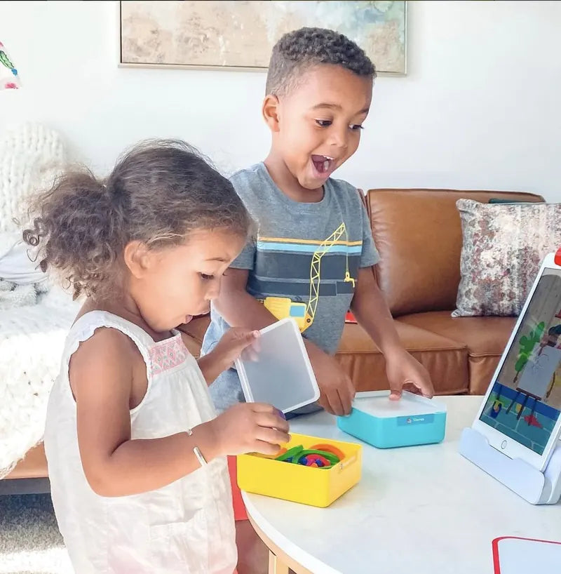 A little one playing with the Little Genius Starter Kit at home