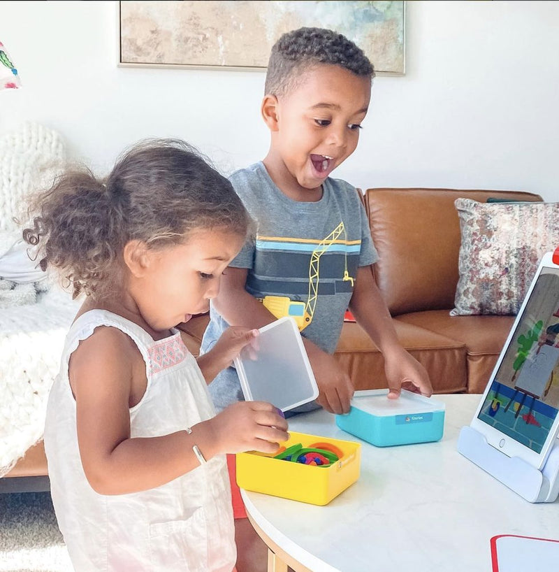 A little one playing with the Little Genius Starter Kit at home
