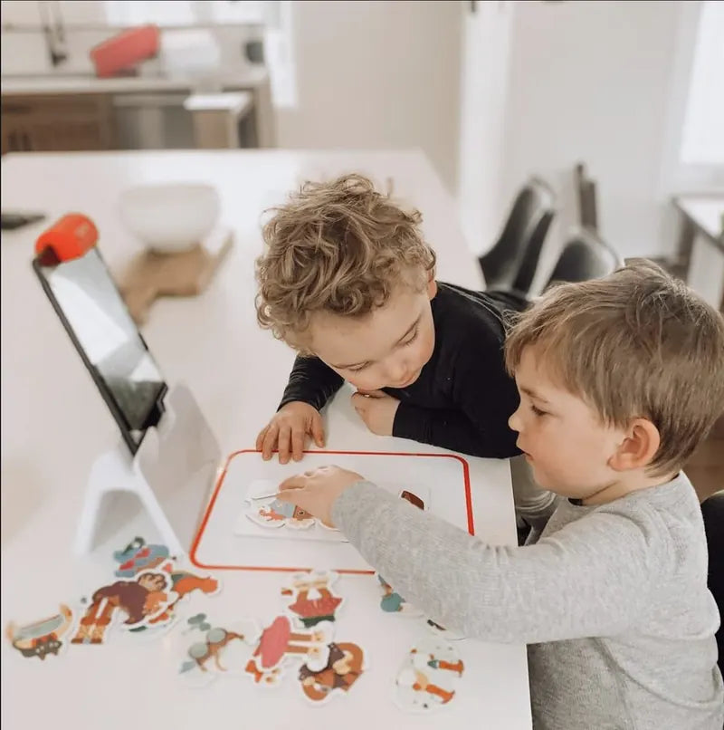 A little one playing with the Little Genius Starter Kit at home