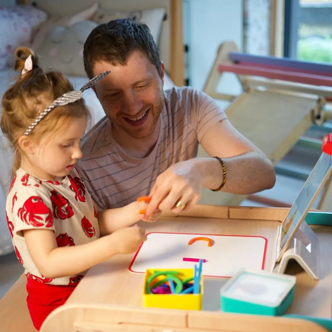 A dad and his young daughter playing Osmo together