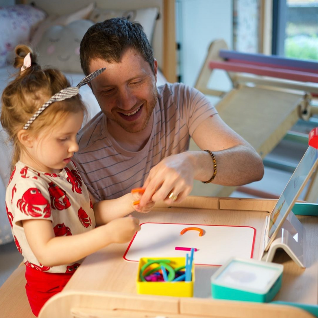 A dad and his young daughter playing Osmo together