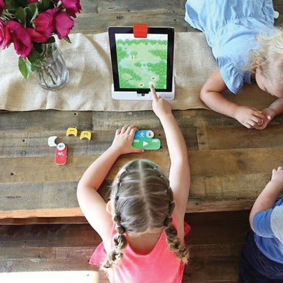 Girl placing Coding Awbie blocks in front of an iPad