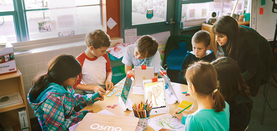 Students using Osmo in a classroom